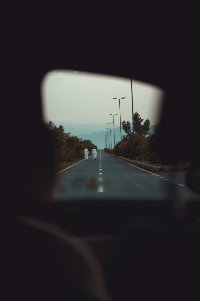 フロントガラス越しに続く道を走る車の風景。車の夢が象徴する人生の方向性や現在の心理状態を表すイメージ